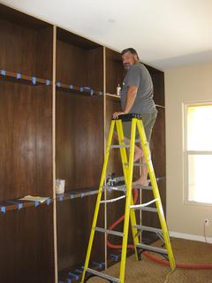 Adding the edge trim to the fixed shelves.